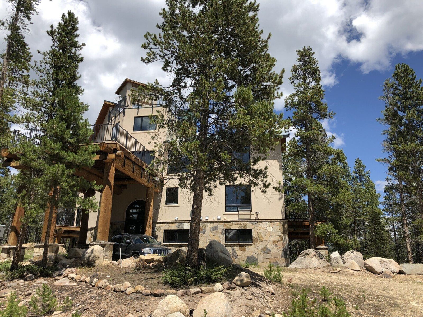 The four-story Sugarloaf Mountain Lodge with log posts and iron-railed decks among lodgepole pines